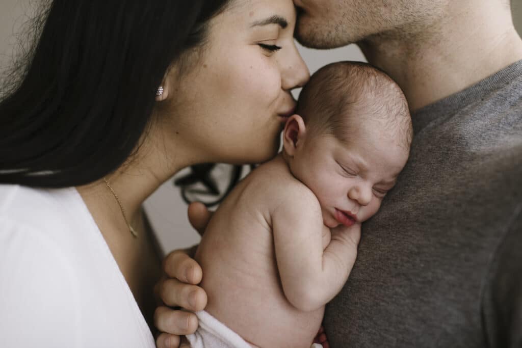 Andrea Bombino at Made to Mother Co kisses her newborn's head