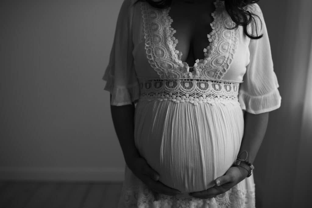 Made to Mother Co's Andrea Bombino cradles her pregnant belly. In this post she discusses matrescence and its importance.